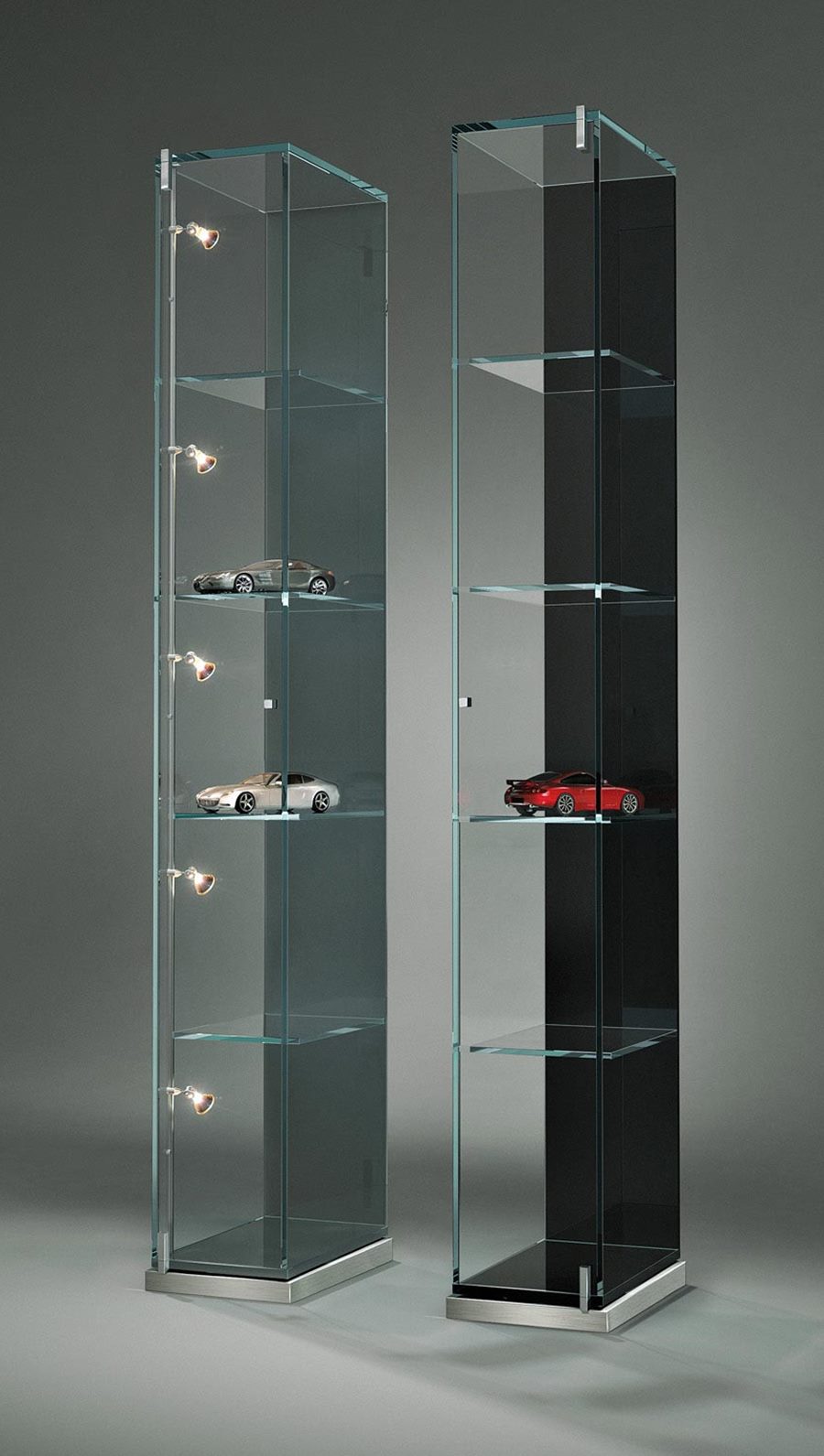 Two slim FACTUM glass display cabinets in grey and black finishes